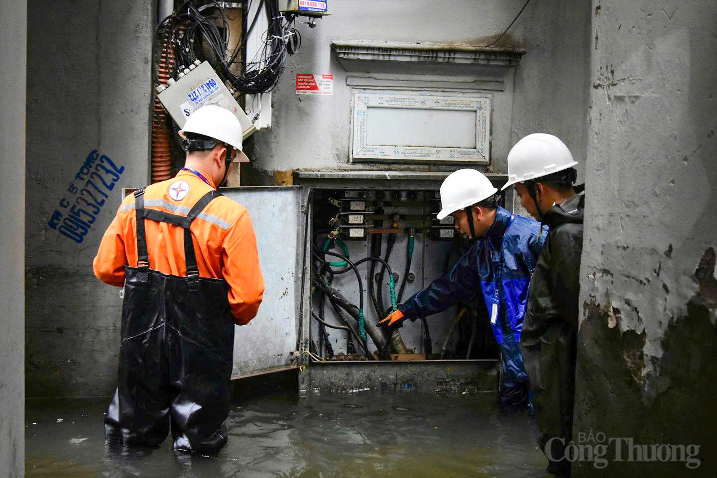 Cán bộ EVNHANOI đội mưa, đi từng ngõ nhỏ hướng dẫn dân vùng ngập