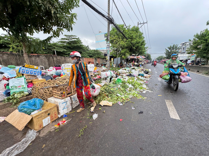 Rác thải tràn ra trên đường Nguyễn Thị Sóc. Ảnh: Ngân Nga