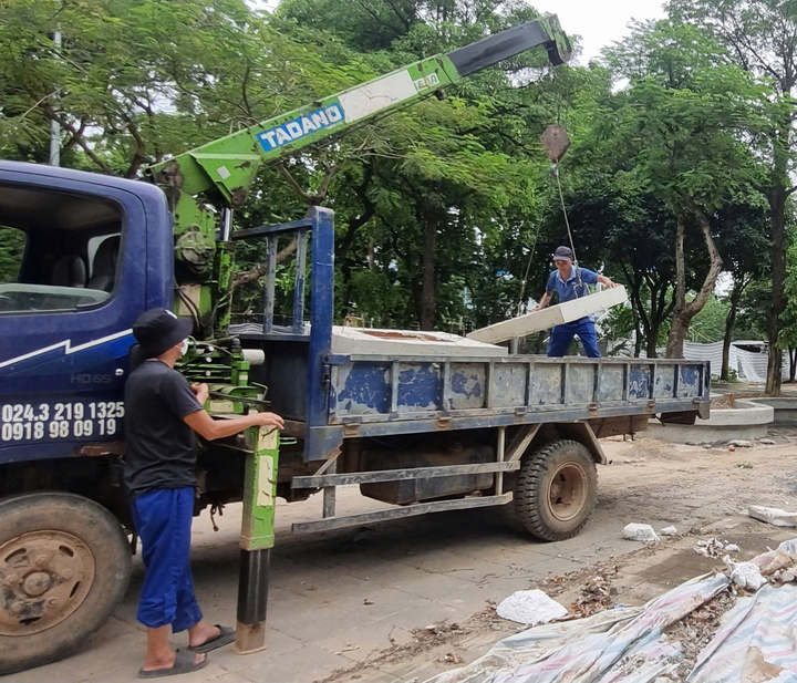 Công nhân dùng xe cẩu vận chuyển vật liệu phục vụ thi công.