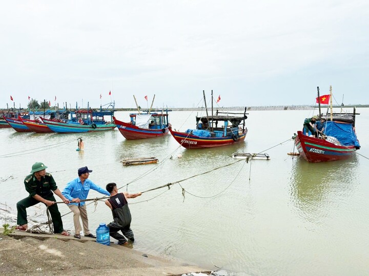 Lực lượng chức năng phối hợp đưa tàu thuyền của ngư dân vào bờ tránh trú. Ảnh: Phúc Sơn
