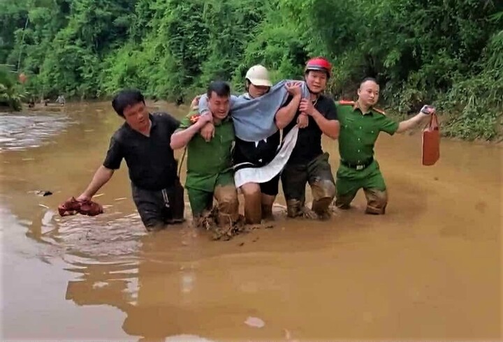 Công an xã Hữu Kiệm vượt lũ đưa sản phụ đến trung tâm y tế. Ảnh: Phúc Sơn