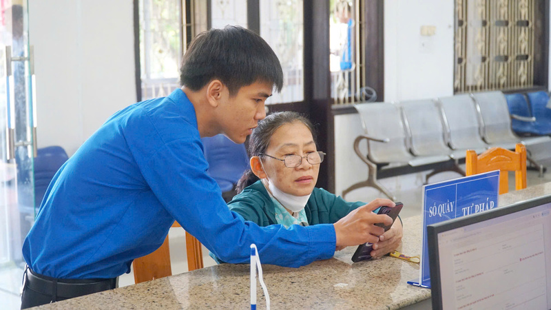 Đoàn viên, thanh niên hỗ trợ, hướng dẫn người dân trong việc hoàn thành các thủ tục hành chính. Ảnh: Hiếu Minh