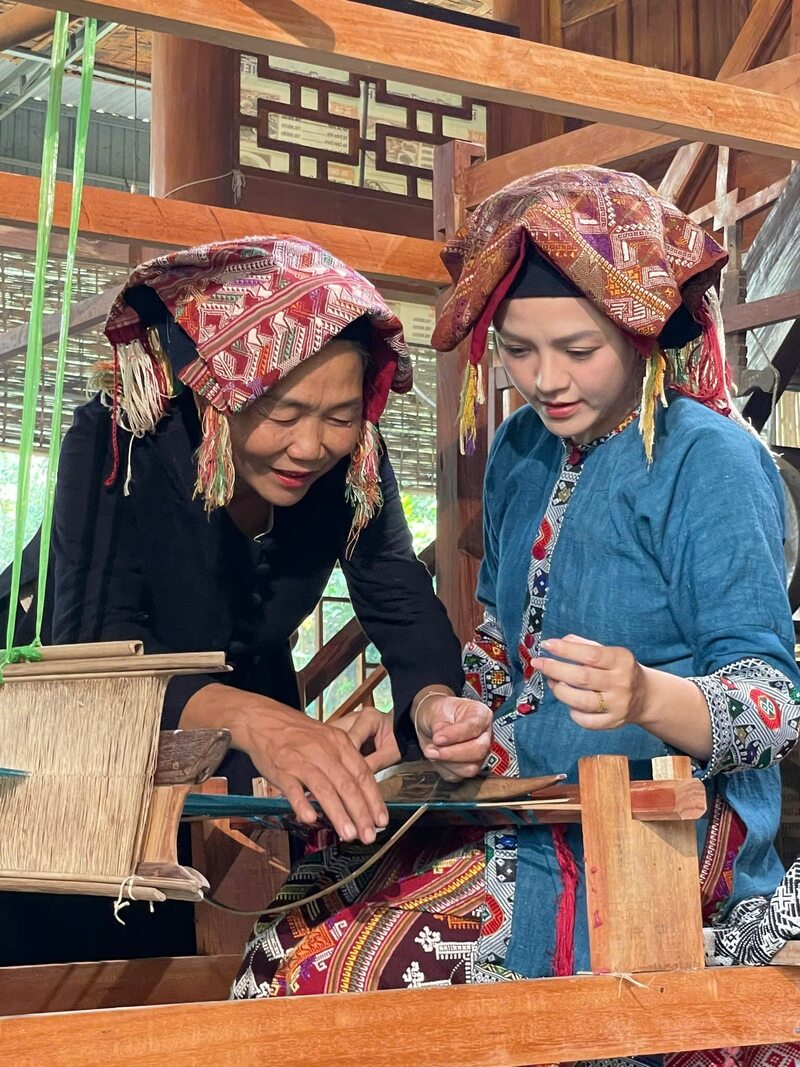 Nghệ nhân Sầm Thị Bích (trái) bên khung cửi dệt thổ cẩm (Ảnh: NVCC)