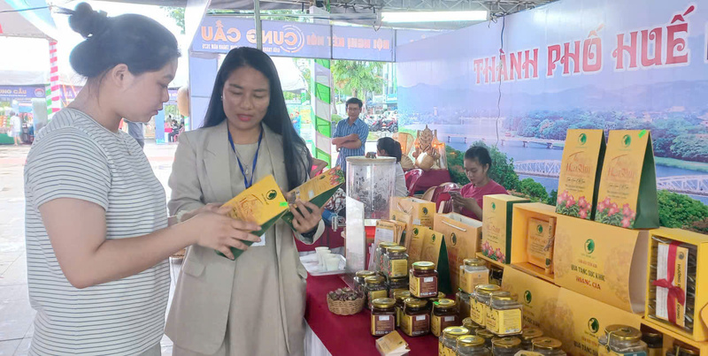 Người tiêu dùng trao đổi với đại diện doanh nghiệp tại gian trưng bày sản phẩm. Ảnh: Nguyễn Tuấn.