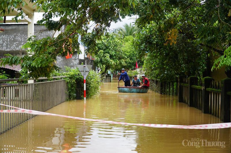 Người dân dùng thuyền thúng di chuyển tại khu vực ngập sâu.