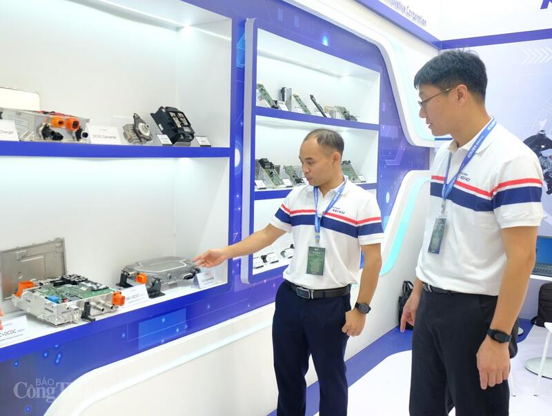 Ông Sangkyu Park (bên phải) cùng nhân viên của Hyundai Kefico giới thiệu về bộ chuyển đổi năng lượng trên xe điện được sản xuất tại nhà máy ở TP. Hải Phòng. Ảnh: Lê An
