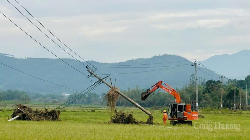Cán bộ ngành điện Đắk Lắk đang khắc phục cột điện bị ngã đổ ở cánh đồng do bão số 13 gây nên. Ảnh: Hồng Hoa