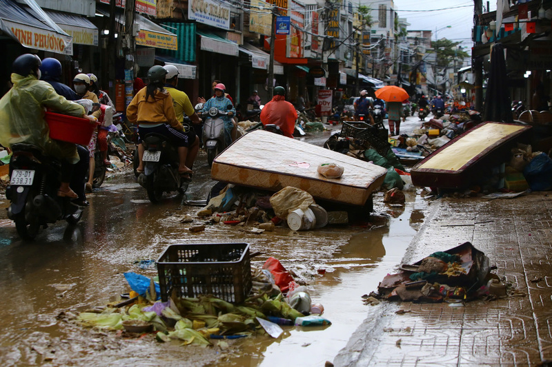 Khi nước lũ đã rút, để lộ ra các lớp bùn, sình và đồ dùng sinh hoạt của người dân bị cuốn trôi ra đường. Ảnh: Xuân Ngọc.