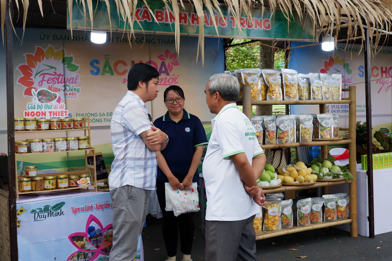 Khách tham quan tìm hiểu và mua sắm các sản phẩm OCOP đặc trưng của địa phương tại gian hàng trưng bày trong khuôn khổ Festival Hoa – Kiểng Sa Đéc. Ảnh: Minh Anh
