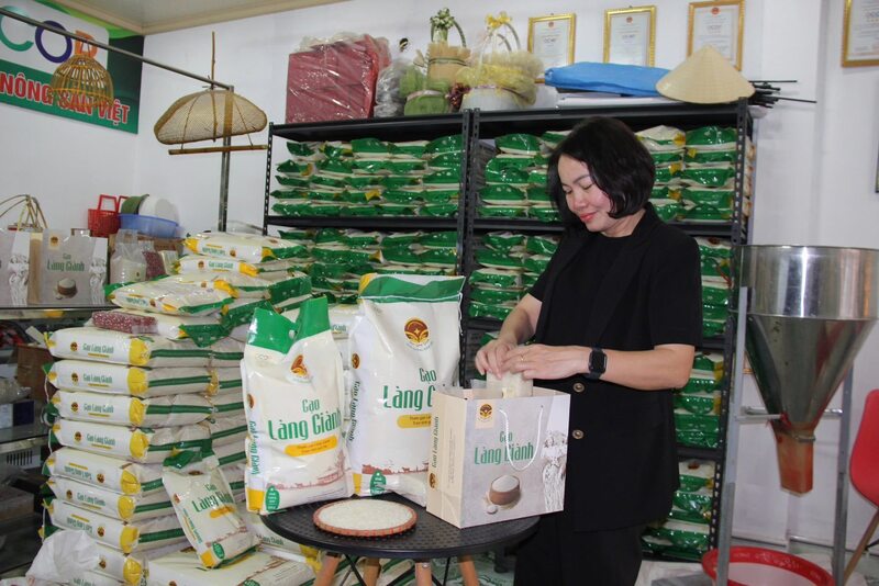 Bà Nguyễn Thị Mai bên cạnh sản phẩm gạo làng Giành. Ảnh: N.M
