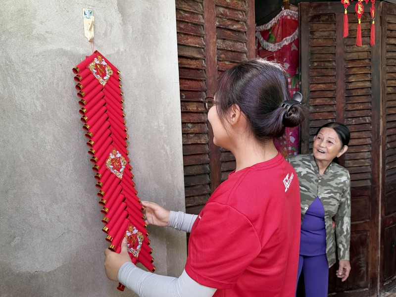 Tình nguyện viên của chương trình trang hoàng lại nhà đón Tết cho các cụ già neo đơn. Ảnh: HL