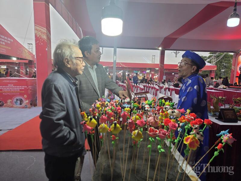 Người mua tìm hiểu về sản phẩm và truyền thống của nghề làm tò he.