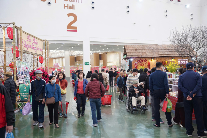 Dòng người đổ về Hội chợ Mùa Xuân để mua sắm, các gian hàng đông kín khách hàng tham quan, trải nghiệm ẩm thực, văn hóa đặc sắc từ 34 tỉnh thành. (Ảnh: Mai Linh)