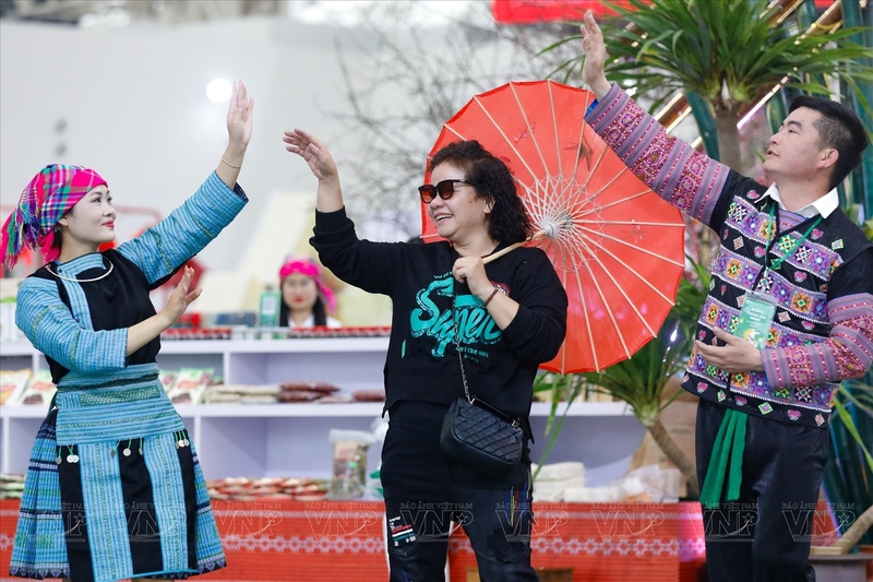 Du khách tham gia múa hát cùng các chàng trai, cô gái Mông. Ảnh: Việt Cường/Báo ảnh Việt Nam