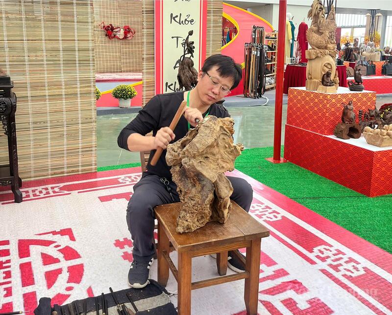 Nghệ nhân Ưu tú Đỗ Văn Cường, Chủ tịch Hội Làng nghề chạm khắc gỗ mỹ nghệ Thiết Úng (xã Thư Lâm, TP. Hà Nội) trình diễn nghề tại Hội chợ Mùa Xuân. Ảnh: N.H