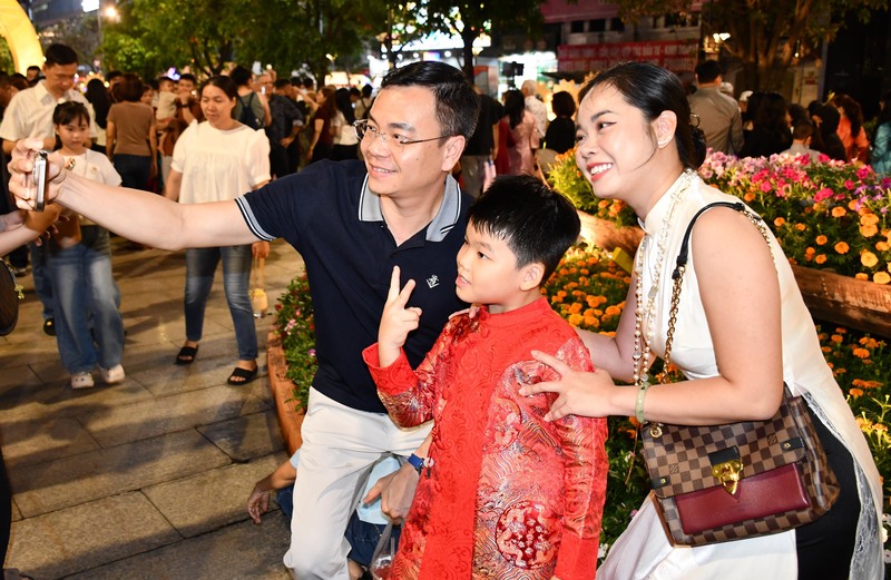 Một gia đình lưu giữ những khoảnh khắc đẹp ngay trong đêm khai mạc. Ảnh: Minh Khuê.