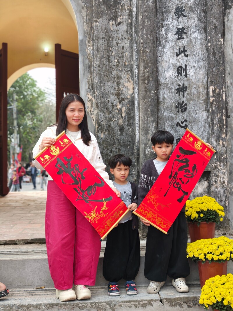 Xin chữ, chụp ảnh lưu niệm tại cổng Văn miếu Xích Đằng.