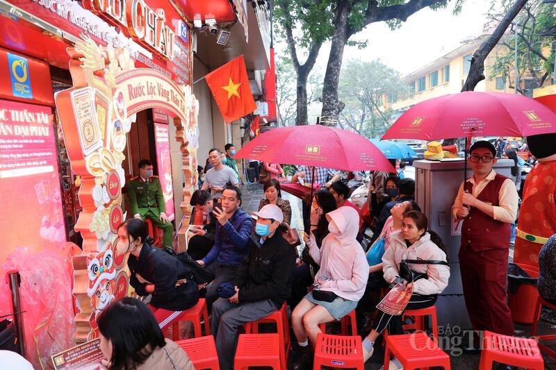 Từ khoảng 5 giờ, khu vực phố Trần Nhân Tông (quận Hai Bà Trưng, Hà Nội) đã đông nghịt người. Trước cửa các thương hiệu lớn như SJC, DOJI, Bảo Tín Minh Châu và Bảo Tín Mạnh Hải, khách hàng xếp hàng trật tự, chờ đến lượt mua vàng trong ngày vía Thần Tài.