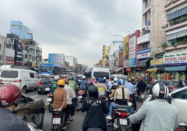 Người dân TP. Hồ Chí Minh di chuyển trong giờ cao điểm giữa bầu trời nhiều mây; chất lượng không khí duy trì ở mức trung bình.