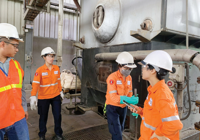 Giáo sư Vũ Thị Thu Hà làm việc với các kỹ sư tại Nhà máy xi măng Tân Thắng. Ảnh: NVCC