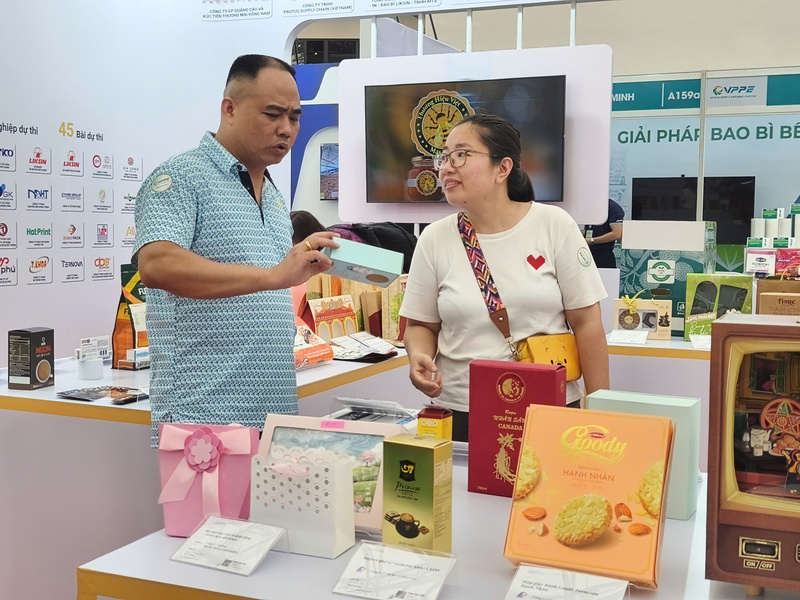 Đại diện doanh nghiệp tìm hiểu các mẫu bao bì tại triển lãm. Ảnh: Nguyễn Hoà