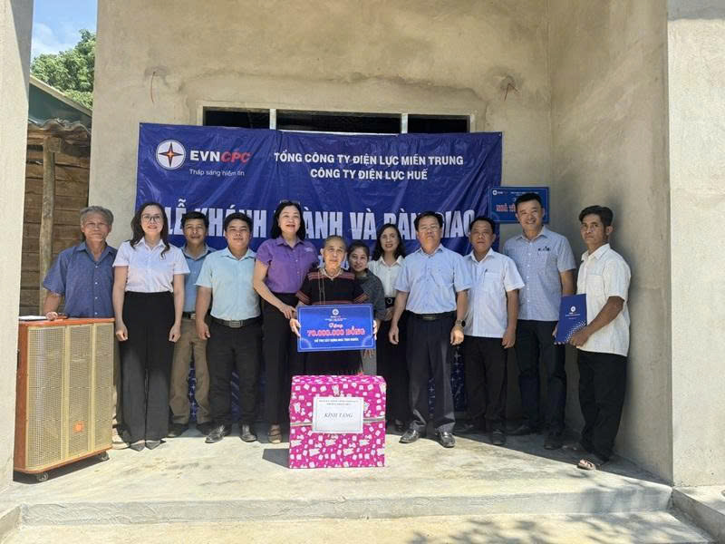 Đại diện Công ty Điện lực Huế và các cấp chính quyền địa phương trao tặng quà mừng khánh thành, bàn giao nhà tình nghĩa hộ gia đình bà Lê Thị Lương. Ảnh: D. Huyền