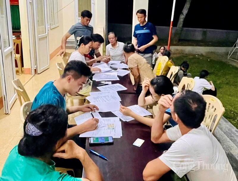 Dù vào thời điểm tối muộn, song các cán bộ xã, thôn vẫn tranh thủ thời gian hướng dẫn người dân đăng ký tài khoản ngân hàng, cập nhật thông tin cá nhân. Ảnh: Ngô Nhung