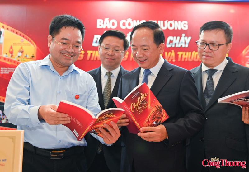 Nhà báo Nguyễn Văn Minh - Tổng Biên tập Báo Công Thương giới thiệu với các đại biểu tập bút ký chính luận "Trên cây cầu bắc qua nửa vòng trái đất" - Ảnh: Nam Nguyễn