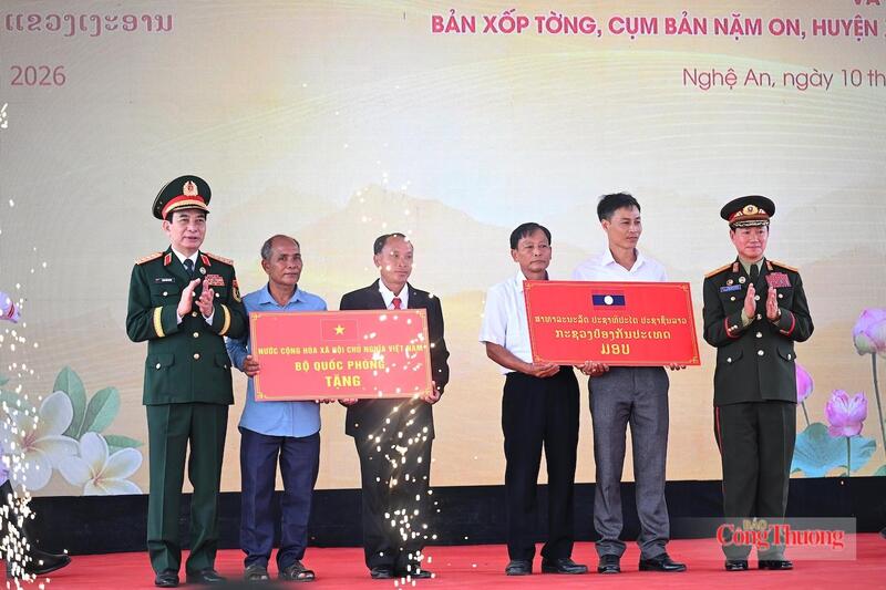 Hai đồng chí Phó Thủ tướng Chính phủ, Bộ trưởng Bộ Quốc phòng hai nước Việt Nam - Lào tặng quà cho đại diện ban quản lý thôn Thủy Phong và Xốp Tờng. Ảnh: Nguyên Khánh