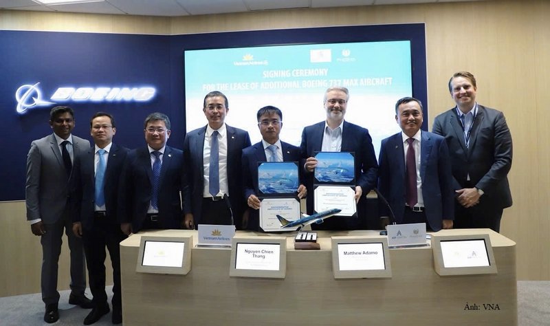 Ông Nguyễn Chiến Thắng, Phó Tổng giám đốc Vietnam Airlines và ông Mathew Adamo - Thành viên điều hành của AIP Capital LLC trao đổi biên bản kí kết