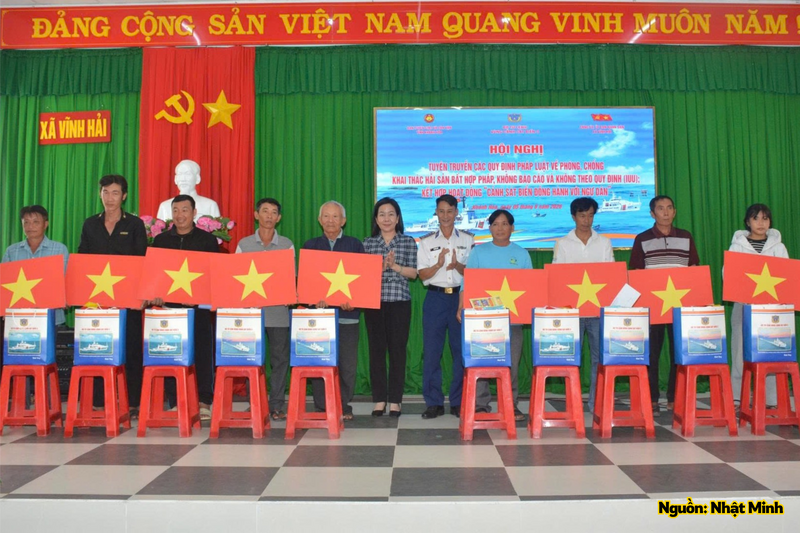 Ban tổ chức tặng quà và cờ Tổ quốc cho gia đình chính sách có hoàn cảnh khó khăn.