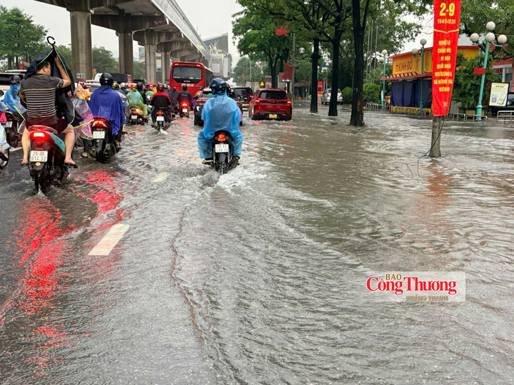 Người dân đội mưa lớn đi làm sáng 17/9.