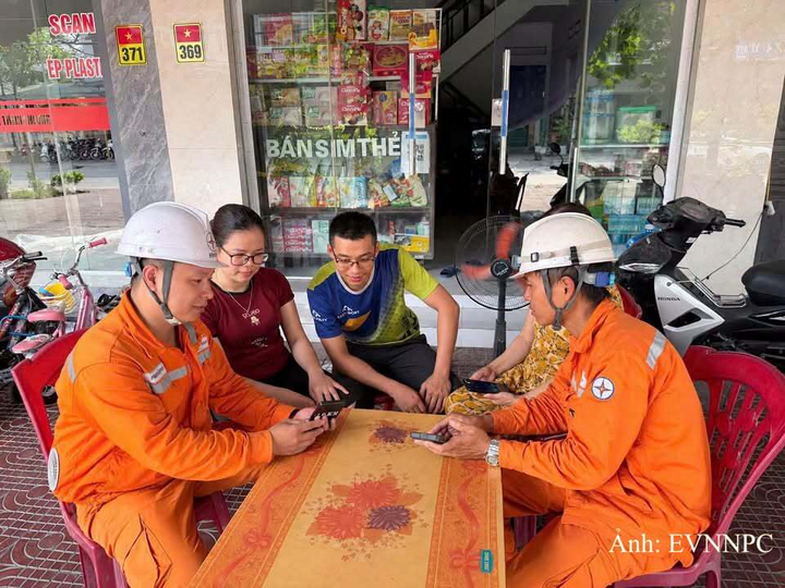 Nhân viên Điện lực Đông Triều, CTĐL Quảng Ninh tuyên truyền, hướng dẫn khách hàng cài đặt ứng dụng EVN CSKH.