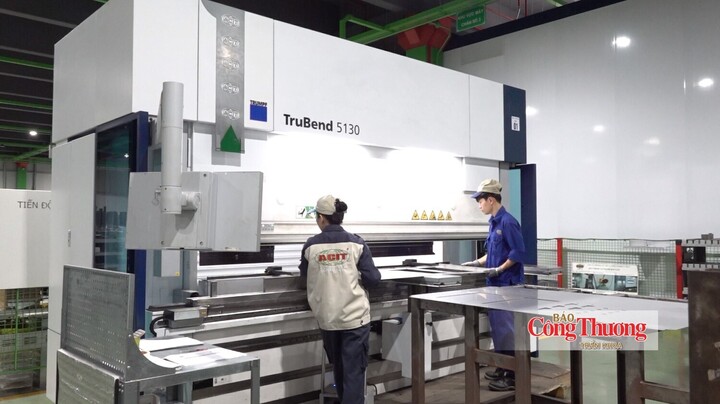 Công nhân gia công chi tiết kim loại trên hệ thống máy móc hiện đại.
