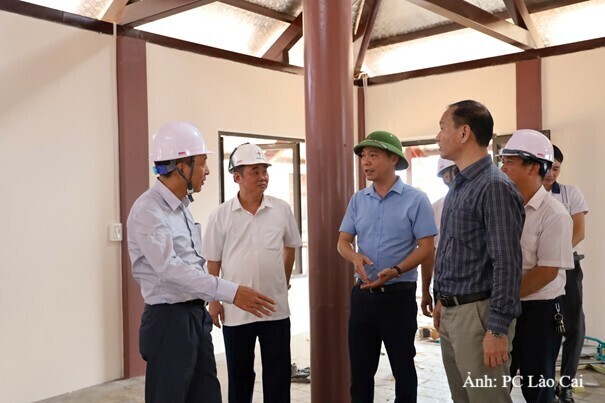 Giám đốc Công ty Điện lực Lào Cai Nguyễn Anh Tuấn (người đứng đầu tiên từ trái sang) trong ngày đóng điện dự án tái thiết Làng Nủ.