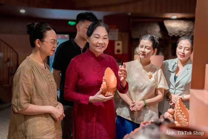 Nghệ nhân Hà Thị Vinh (áo dài đỏ) trăn trở với việc gìn giữ và phát huy giá trị gốm Bát Tràng trong bối cảnh chuyển đổi số.