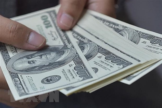 Đồng tiền mệnh giá 100 USD. (Ảnh: AFP/TTXVN) Đồng tiền mệnh giá 100 USD. (Ảnh: AFP/TTXVN)