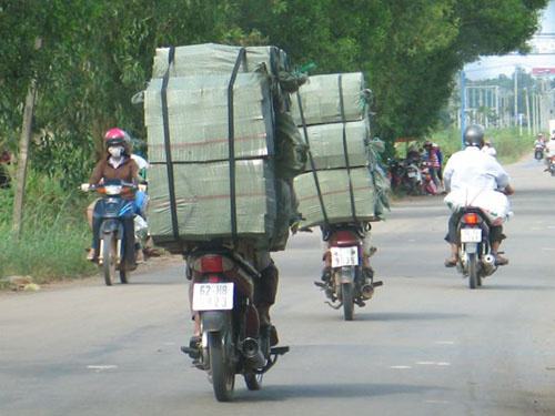 Sử dụng xe máy vận chuyển thuốc lá lậu trên đường ở tỉnh Long An.
