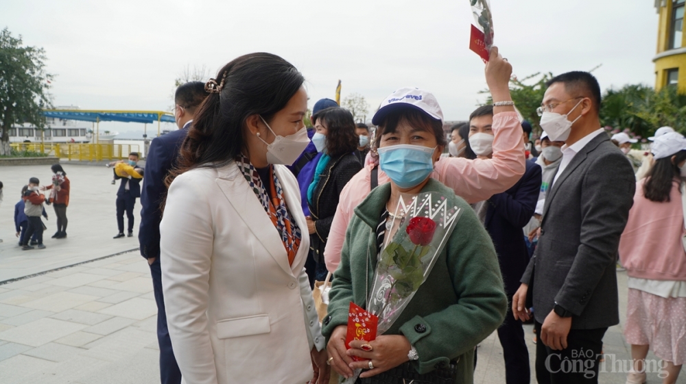 Bà Nguyễn Thị Hạnh, Phó Chủ tịch UBND tỉnh Quảng Ninh tặng hoa và lì xì cho khách du lịch xông đất đầu năm mới.