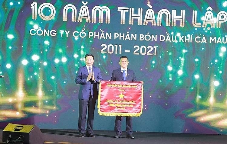 Tổng Giám đốc Petrovietnam Lê Mạnh Hùng trao cờ thi đua cho đại diện lãnh đạo PVCFC để ghi nhận những thành tích xuất sắc trong phong trào thi đua và những đóng góp to lớn của Công ty đối với ngành Dầu khí