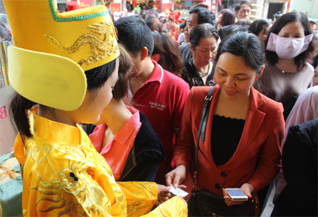 Nhân viên tiệm vàng này đang phát số thứ tự cuối cùng cho khách trong sáng nay