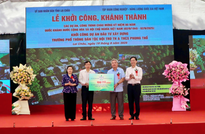 Đại diện Tập đoàn Công nghiệp - Năng lượng quốc gia Việt Nam trao tiền hỗ trợ dự án Đầu tư xây dựng Trường phổ thông Dân tộc nội trú Tiểu học và THCS Phong Thổ cho các đồng chí lãnh đạo tỉnh Lai Châu. Ảnh: Ngọc Duy
