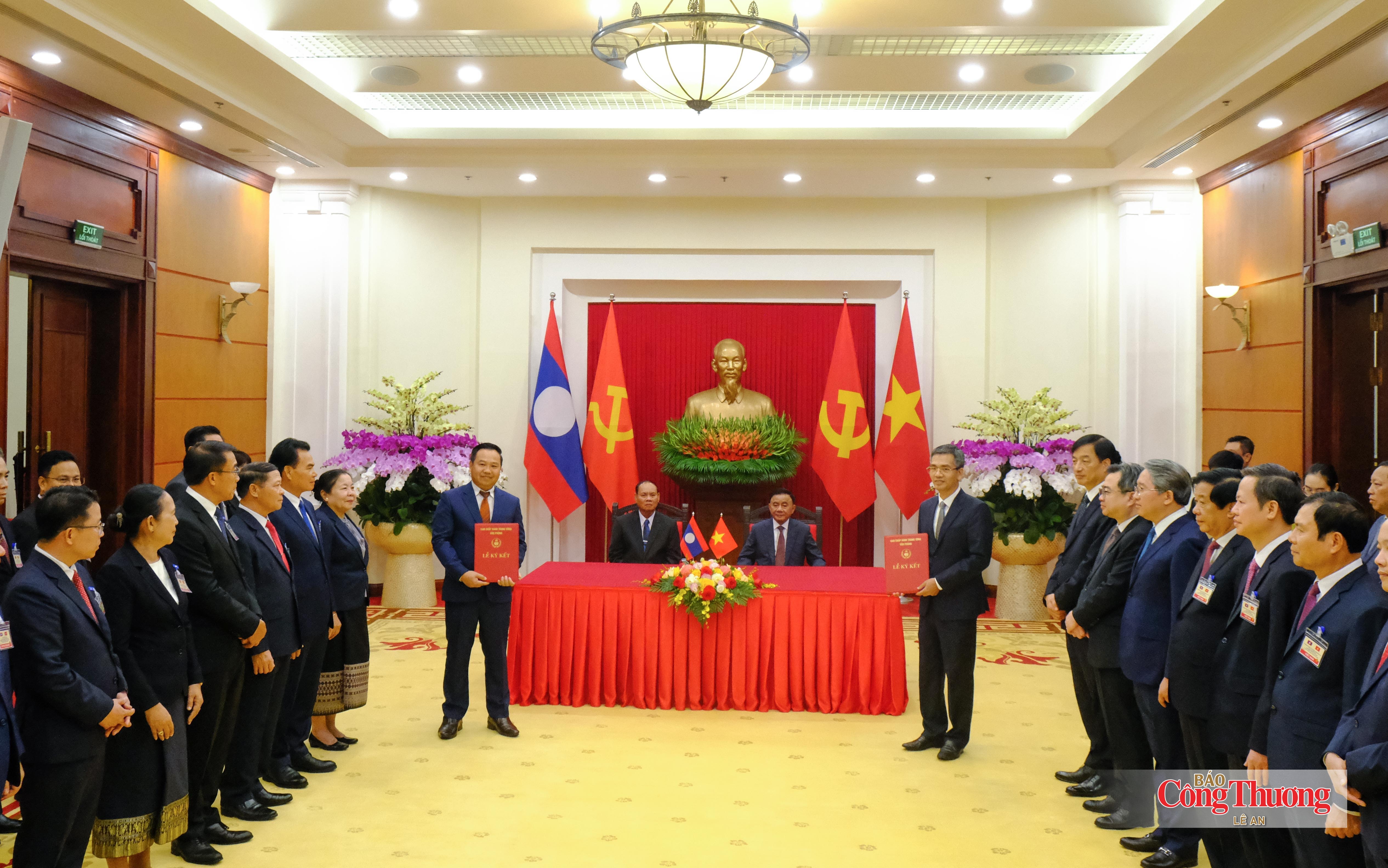 Đồng chí Trần Cẩm Tú, Ủy viên Bộ Chính trị, Thường trực Ban Bí thư và đồng chí Vilay Lakhamphong, Ủy viên Bộ Chính trị, Thường trực Ban Bí thư Trung ương Đảng Nhân dân Cách mạng Lào chứng kiến Lễ trao văn kiện hợp tác về Đề án chuyển đổi số giữa Văn phòng Trung ương Đảng và Văn phòng Trung ương Đảng Lào.